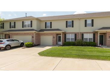 A home's exterior showcases its well-manicured lawn, a car in the driveway and attached garages at 4104 Bullfinch Way, Westfield, IN 46062