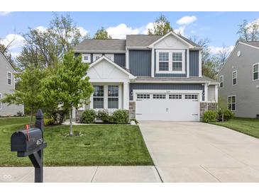 Charming two-story home boasts blue and gray siding, a two-car garage, and a well-manicured lawn at 4629 Rainwater Ln, Whitestown, IN 46075