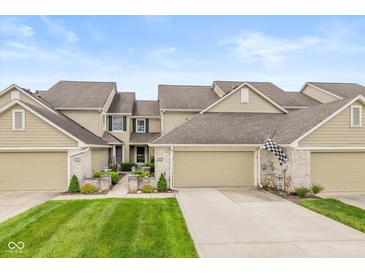 Charming townhome with an attached two-car garage, well-maintained lawn, and welcoming front entrance at 5744 Spruce Knoll Ct, Indianapolis, IN 46220