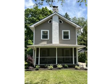 Charming home featuring a screened front porch, light-colored siding and white trim at 5829 Broadway St, Indianapolis, IN 46220