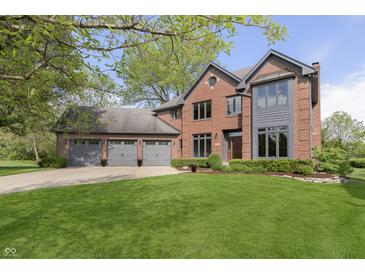 Charming brick two-story home featuring a well-manicured lawn and a three-car garage at 839 Pebble Brook Pl, Noblesville, IN 46062
