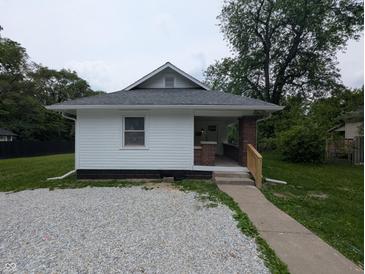 Charming single-story home featuring a gravel front yard and a cozy, covered entrance with brick columns at 1009 Chestnut St, Anderson, IN 46012