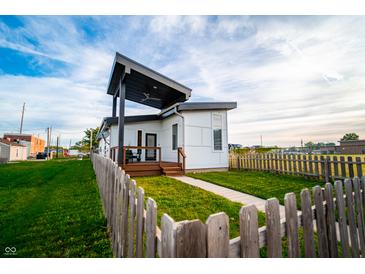 Striking modern home features a stylish covered porch and well-manicured lawn at 1112 Spann Ave, Indianapolis, IN 46203