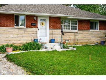 Charming brick home with a well-maintained lawn and landscaped front yard at 349 Clark Ave, Beech Grove, IN 46107