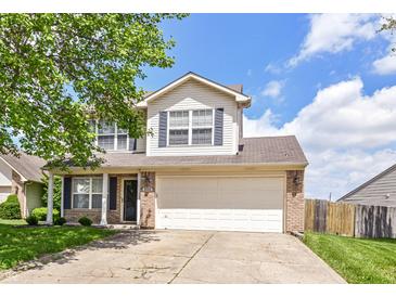 Charming two-story home with a well-manicured lawn, brick accents, and an attached two-car garage at 8108 Amarillo Dr, Indianapolis, IN 46237