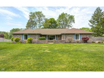 Charming brick home featuring a lush green lawn, mature trees, and lovely landscaping at 101 N Westbury Rd, Pendleton, IN 46064