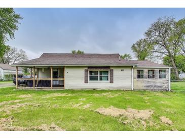Charming single-story home featuring vinyl siding, a screened porch, and a well-maintained lawn at 115 S Center St, Maxwell, IN 46154