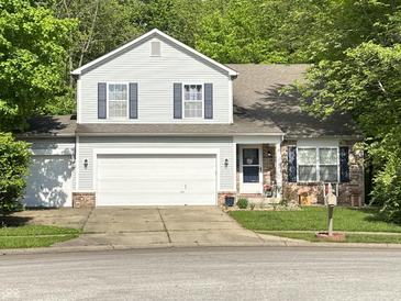 Charming two-story home with a two car garage, brick accents, and well-manicured lawn at 1334 Legacy Ct, Indianapolis, IN 46234