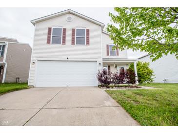 Two-story home features a two-car garage, a front lawn, and landscaping at 1404 Norton Dr, Greenwood, IN 46143