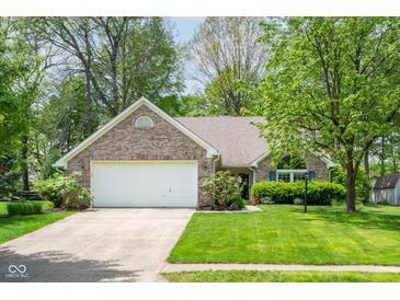Charming single-story brick home featuring an attached two-car garage and a well-manicured front lawn at 19519 Creekview Dr, Noblesville, IN 46062