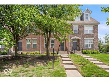 Brick townhome featuring meticulous landscaping, sidewalks and inviting front entrances at 2405 N Park Ave, Indianapolis, IN 46205