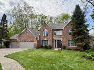 Beautiful two-story brick home with mature landscaping and a three car garage at 2884 Brook Vista Dr, Carmel, IN 46032