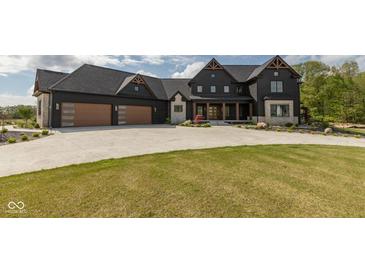 Stunning two-story home with a dark exterior, three-car garage, and professionally landscaped front yard at 4078 Besbie Way, Bargersville, IN 46106