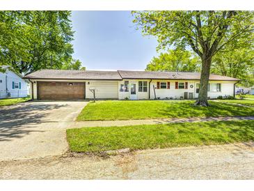 Charming single-story home featuring a well-maintained lawn and a two-car attached garage at 423 W Janet Dr, Brownsburg, IN 46112