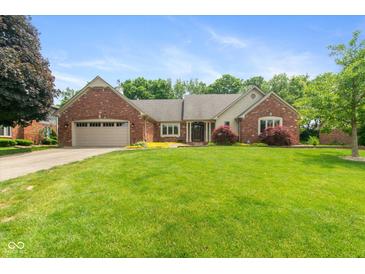 Charming brick home with a well-manicured lawn, attached garage, and beautiful landscaping at 4351 W Fox Ridge Ave, Greenwood, IN 46143