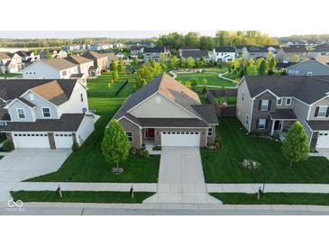 Beautiful aerial view of home showing manicured lawn and community park with walking trails and playground at 934 Steel Horse Dr, Westfield, IN 46074