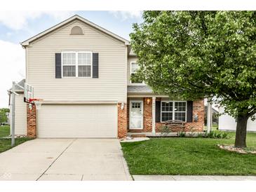 Charming two-story home featuring vinyl siding, brick accents, and an attached two-car garage at 941 Pine Ridge Way, Brownsburg, IN 46112