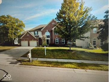 Traditional brick two-story home with a two-car garage and manicured front lawn at 9879 Brightwater Dr, Fishers, IN 46038