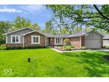 Charming single-story brick home with a well-manicured lawn and landscaping at 10444 Collingswood Ln, Fishers, IN 46037