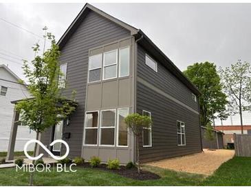 Modern two-story home with gray siding and multiple windows allowing for lots of natural light at 1215 Herbert St, Indianapolis, IN 46202