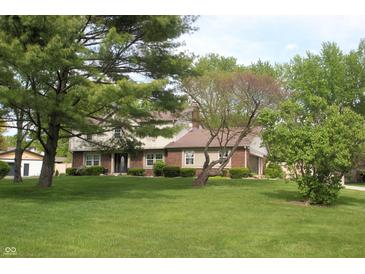 Charming two-story home with brick and siding exterior, mature trees, and a well-manicured lawn at 15203 Shoreway Ct, Carmel, IN 46032