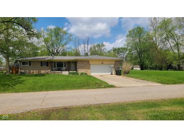 Charming single story home with a stone facade, mature trees and an attached two car garage at 2867 S Oakland Dr, Shelbyville, IN 46176