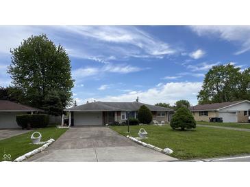 Charming one-story home featuring a well-maintained lawn and a long driveway at 2927 E 8Th St, Anderson, IN 46012