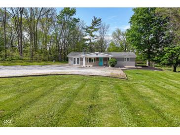 Charming single-story home with a blue front door and well-manicured lawn at 296 W Greencastle Rd, Mooresville, IN 46158