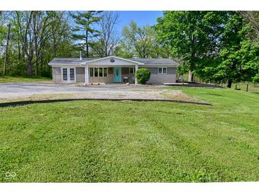Single-story home with a front porch, manicured lawn, and mature trees at 296 W Greencastle Rd, Mooresville, IN 46158