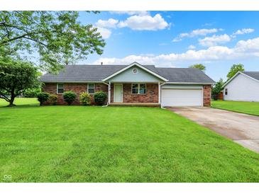 Charming brick home with an attached garage and well-manicured front yard with beautiful curb appeal at 374 S Baldwin St, Bargersville, IN 46106