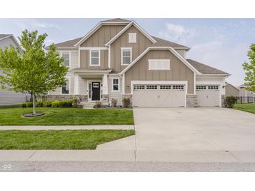 Beautiful two-story home with a well-manicured lawn and a three car garage at 6101 Hardwick Dr, Whitestown, IN 46075