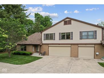 Inviting two-story home with a brick facade and a spacious two-car garage and concrete driveway at 774 Chapel Pines W Dr, Indianapolis, IN 46234