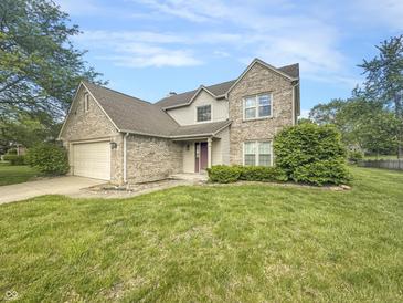 Charming two-story brick home with well-manicured lawn and attached two car garage at 817 Timber Creek Dr, Indianapolis, IN 46239