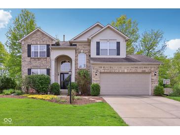 Charming two-story home with a well-manicured lawn, beautiful landscaping, and a two-car garage at 8745 Providence Dr, Fishers, IN 46038