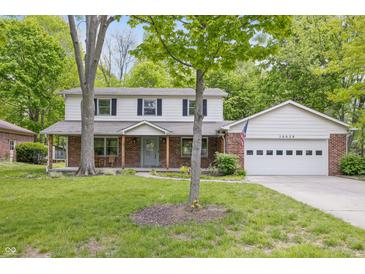 Charming two-story home with a brick facade, a covered front porch, and a well-maintained lawn at 10429 Lasalle Rd, Carmel, IN 46033
