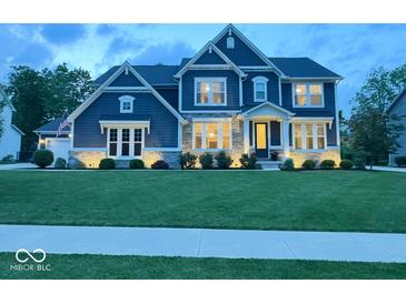 Charming two-story home with manicured lawn, professional landscaping, and classic architectural details at 1050 Windsor Estates Ct, Westfield, IN 46074
