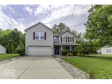 Traditional two-story home boasts a well-manicured lawn and an attached two-car garage at 1119 Albemarle Cir, Noblesville, IN 46062