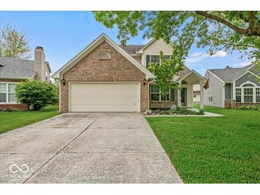 Charming home featuring a brick facade, attached two-car garage, and well-maintained landscaping at 11199 Boston Way, Fishers, IN 46038