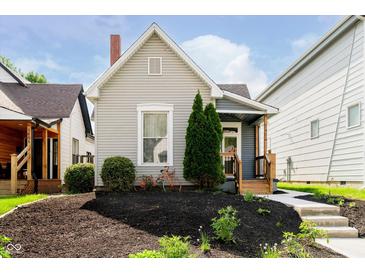 Charming single-story home with a well-maintained lawn and inviting front porch at 1402 Olive St, Indianapolis, IN 46203