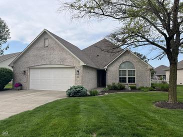 Charming single-Gathering home with a well-manicured lawn and attached two-car garage at 1604 Stonewall Dr, Greenfield, IN 46140