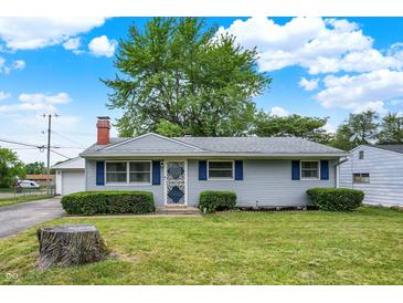 Charming single story home with manicured lawn, shutters, and a brick chimney under a beautiful blue sky at 2726 Dawson St, Indianapolis, IN 46203