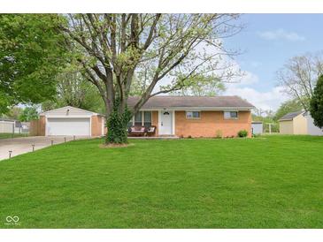 Charming brick ranch home featuring a well-maintained lawn and detached garage at 3723 S Dearborn St, Indianapolis, IN 46237