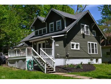 Charming home with a well-maintained lawn, inviting front porch, and lush, mature trees in a neighborhood setting at 455 E Main St, Danville, IN 46122