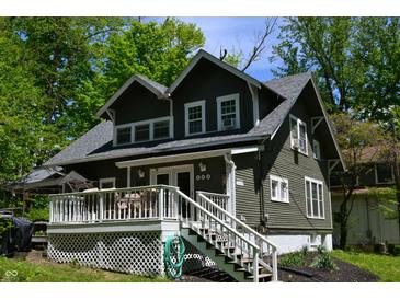 Charming home with a well-maintained lawn, inviting front porch, and lush, mature trees in a neighborhood setting at 455 E Main St, Danville, IN 46122
