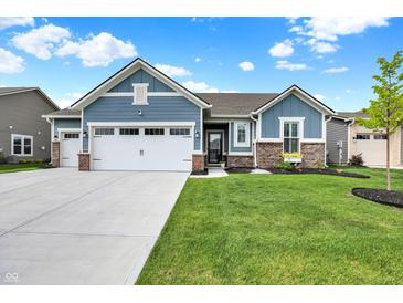 Charming single-Gathering home featuring blue siding, well-maintained landscaping, and a spacious three-car garage at 5248 Holborn Ave, McCordsville, IN 46055