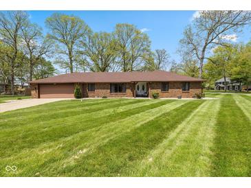 Charming ranch-style home with a manicured lawn, mature trees and attached two-car garage at 5312 Larita Ln, Anderson, IN 46017