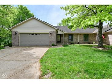 Charming single-story home with a well-maintained lawn and attached two-car garage at 5361 Carnoustie Cir, Avon, IN 46123