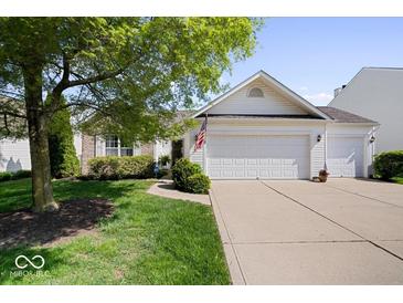 Charming single-Gathering home featuring an attached two-car garage, well-maintained lawn, and mature trees at 5893 Crosscut Ln, Noblesville, IN 46062