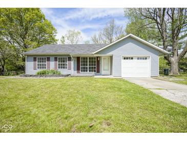 Charming single-story home with light blue siding, an attached garage, and a well-maintained front lawn at 5938 Dunseth Ct, Indianapolis, IN 46254