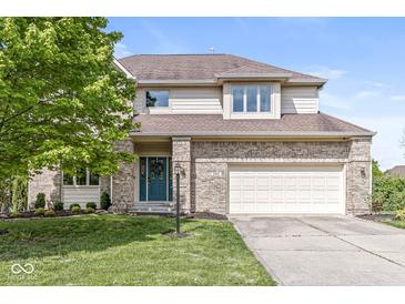 Charming two-story home with brick accents, attached garage, and well-manicured lawn at 6818 Bluffridge Dr, Indianapolis, IN 46278